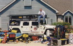 Founder, John Hamrick sits atop the Hummer and displays just some of the equipment he uses during emergencies.